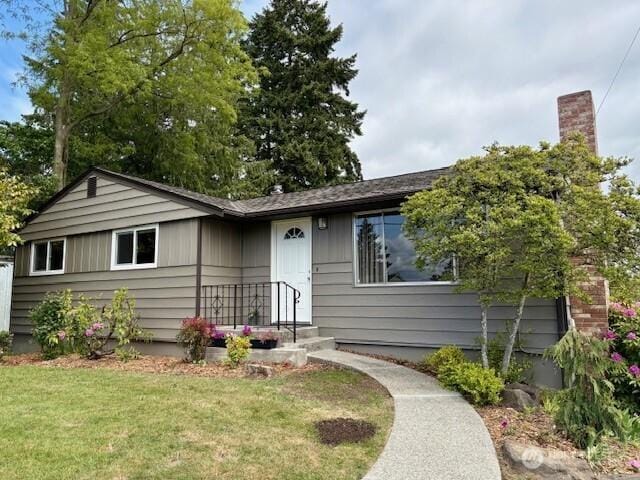 10644 19th Ave SW, Seattle, WA 98146 - view of front facade featuring a front yard and a chimney