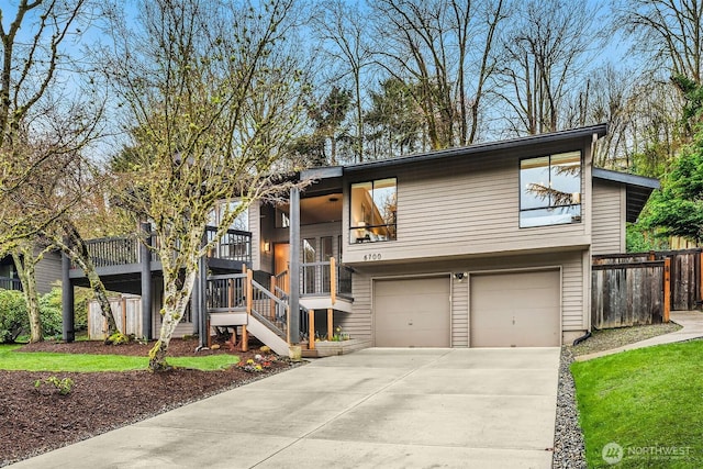 6700 81st Ave SE, Mercer Island, WA 98040 - view of front of home featuring an attached garage, driveway, fence, and stairs