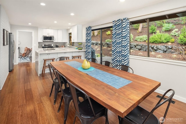 6700 81st Ave SE, Mercer Island, WA 98040 - dining space with wood-type flooring, baseboards, and recessed lighting