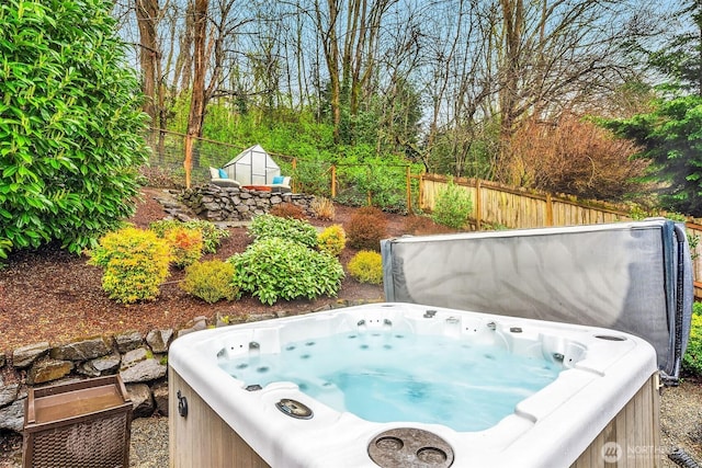 6700 81st Ave SE, Mercer Island, WA 98040 - view of yard with a hot tub, fence, a storage unit, and an outdoor structure