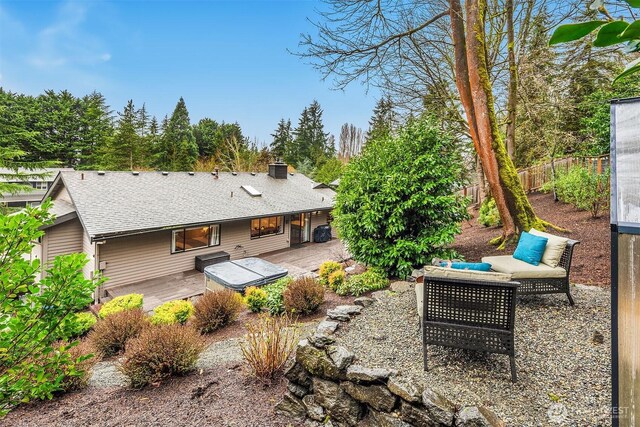 6700 81st Ave SE, Mercer Island, WA 98040 - rear view of house featuring fence, roof with shingles, a wooden deck, a patio area, and a chimney