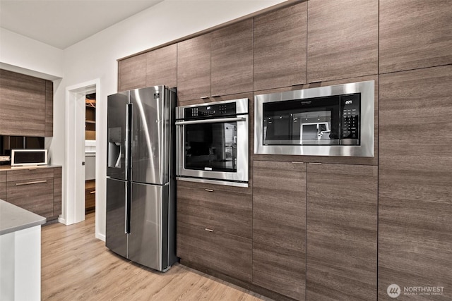 24821 237th Ln SE, Maple Valley, WA 98038 - kitchen with stainless steel appliances, light wood-style flooring, and modern cabinets