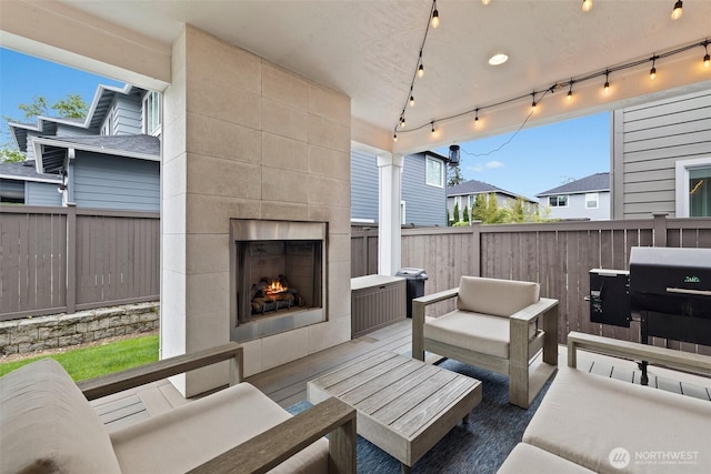 24821 237th Ln SE, Maple Valley, WA 98038 - view of patio / terrace with an outdoor living space with a fireplace