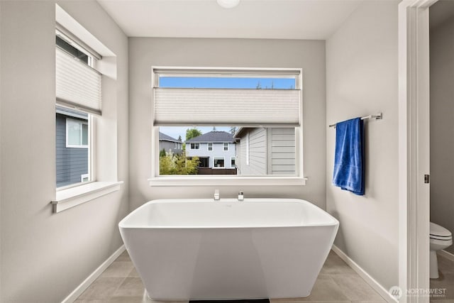 24821 237th Ln SE, Maple Valley, WA 98038 - full bathroom featuring baseboards, a freestanding tub, and toilet