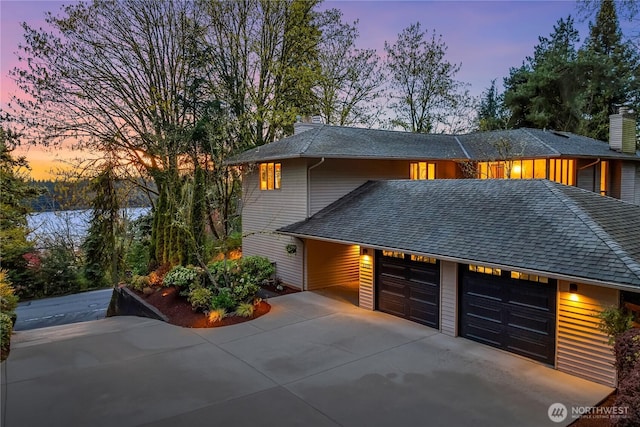 5310 W Mercer Way, Mercer Island, WA 98040 - view of front facade featuring a garage, roof with shingles, driveway, and a chimney