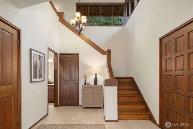 5310 W Mercer Way, Mercer Island, WA 98040 - foyer entrance featuring a high ceiling, a chandelier, stairway, and baseboards