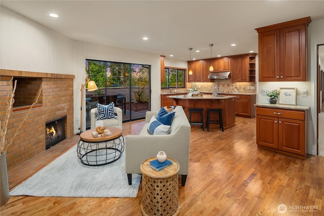 5310 W Mercer Way, Mercer Island, WA 98040 - living area with light wood-type flooring, a brick fireplace, and recessed lighting