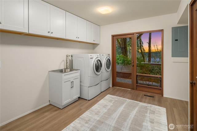 5310 W Mercer Way, Mercer Island, WA 98040 - laundry room with separate washer and dryer, electric panel, light wood finished floors, baseboards, and cabinet space