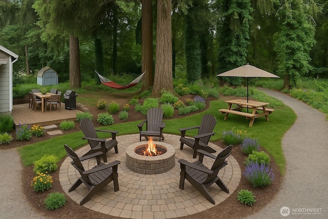 35603 Military Rd S, Auburn, WA 98001 - view of patio / terrace featuring a fire pit, a shed, a wooden deck, outdoor dining area, and a grill