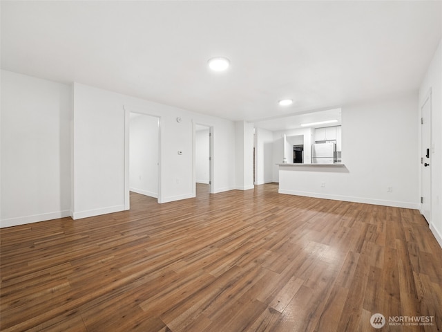 35603 Military Rd S, Auburn, WA 98001 - unfurnished living room with wood finished floors and recessed lighting
