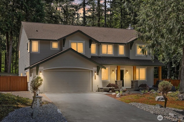 view of front of property with a porch, fence, a shingled roof, and driveway