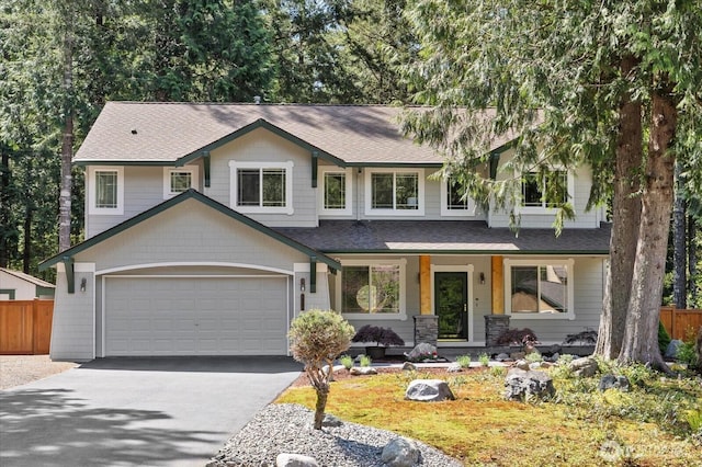 view of front facade featuring fence, asphalt driveway, covered porch, a shingled roof, and a garage