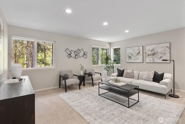 carpeted living room with recessed lighting and baseboards