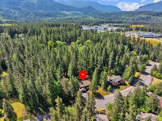 aerial view of a heavily wooded area and mountains