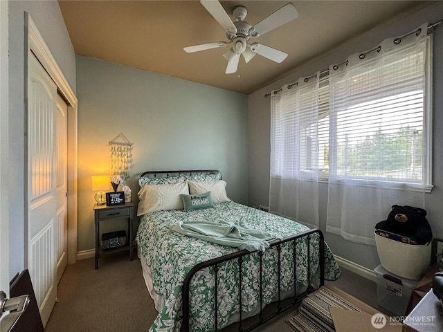 carpeted bedroom with baseboards and a ceiling fan