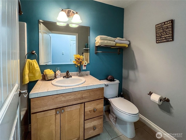 half bath with tile patterned flooring, vanity, and toilet