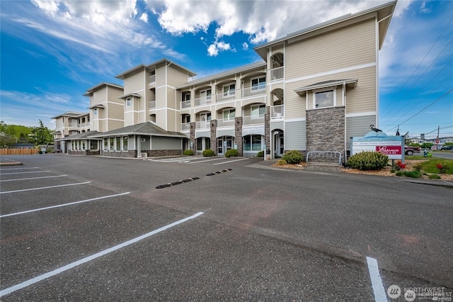 view of property featuring uncovered parking