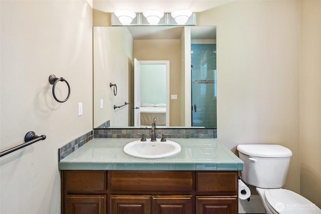 full bath featuring vanity, toilet, and a tile shower