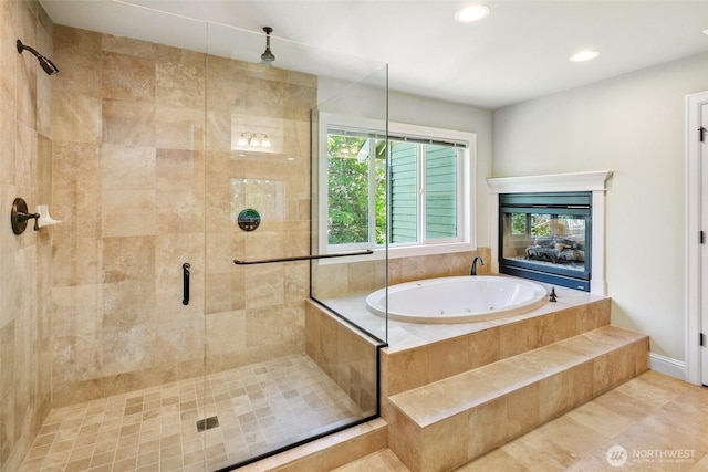 bathroom with a jetted tub, a shower stall, and recessed lighting