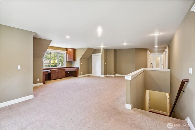 interior space featuring baseboards, light carpet, and recessed lighting