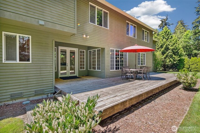 back of house with french doors, a deck, and outdoor dining area