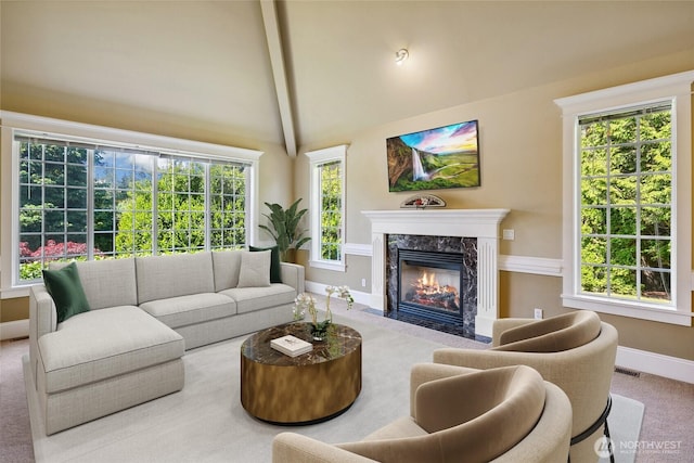 carpeted living room featuring beam ceiling, baseboards, a fireplace, and high vaulted ceiling