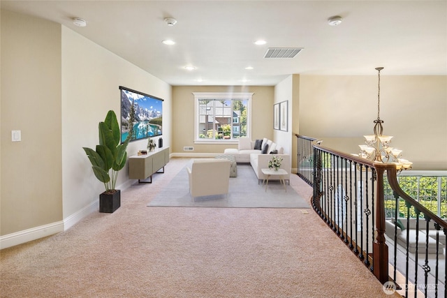living room featuring a chandelier, carpet, baseboards, and recessed lighting