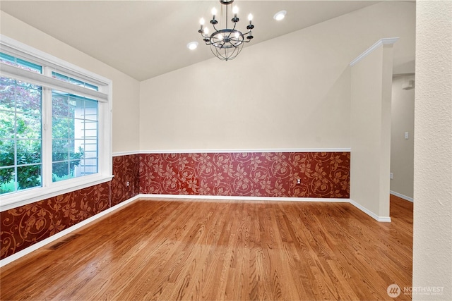 2222 60th Ln NW, Olympia, WA 98502 - spare room with wood finished floors, a chandelier, baseboards, wallpapered walls, and wainscoting