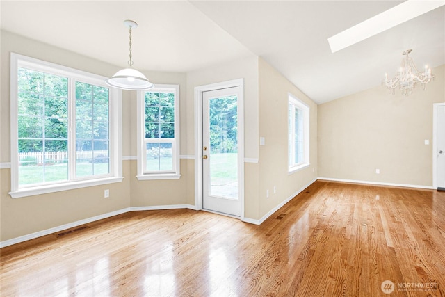 2222 60th Ln NW, Olympia, WA 98502 - unfurnished dining area with a chandelier, wood finished floors, baseboards, and vaulted ceiling