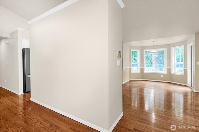 2222 60th Ln NW, Olympia, WA 98502 - empty room with wood finished floors, baseboards, ornamental molding, and vaulted ceiling