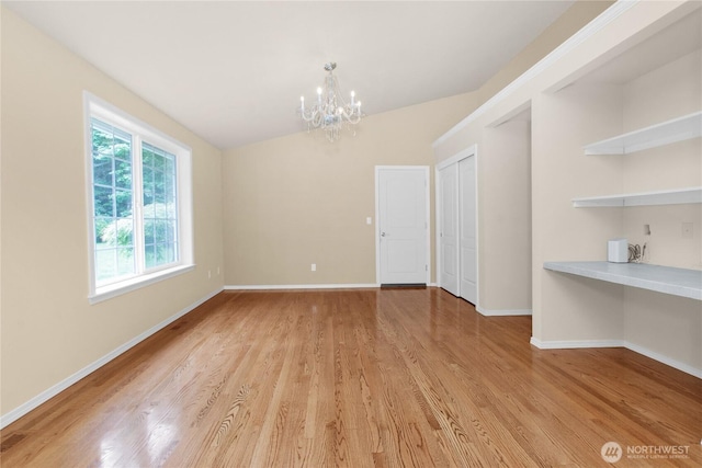 2222 60th Ln NW, Olympia, WA 98502 - unfurnished dining area with a chandelier, light wood-style flooring, and baseboards