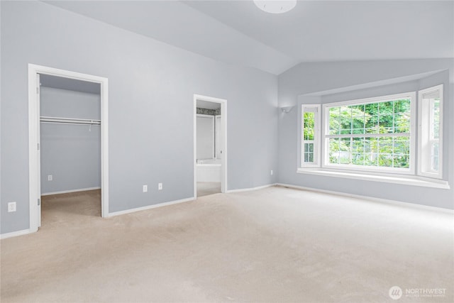 2222 60th Ln NW, Olympia, WA 98502 - unfurnished bedroom with lofted ceiling, carpet flooring, a spacious closet, baseboards, and connected bathroom