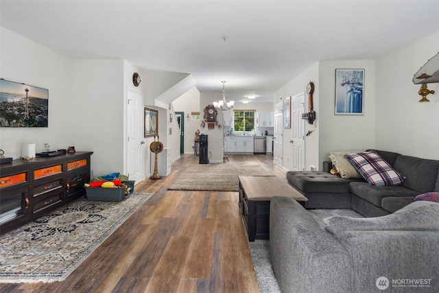 living area featuring hardwood / wood-style flooring and a chandelier