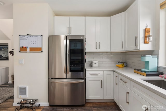 kitchen featuring smart refrigerator, white cabinetry, and light countertops