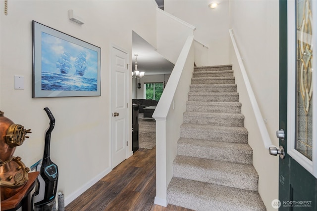 staircase with wood finished floors and baseboards