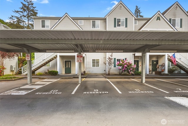 covered parking lot featuring stairway