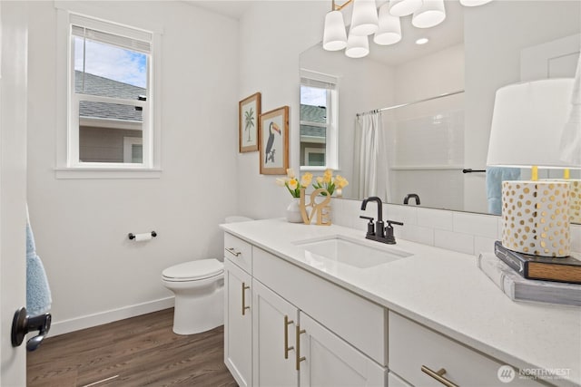 12713 176th Ave E, Bonney Lake, WA 98391 - full bath featuring plenty of natural light, vanity, wood finished floors, and curtained shower