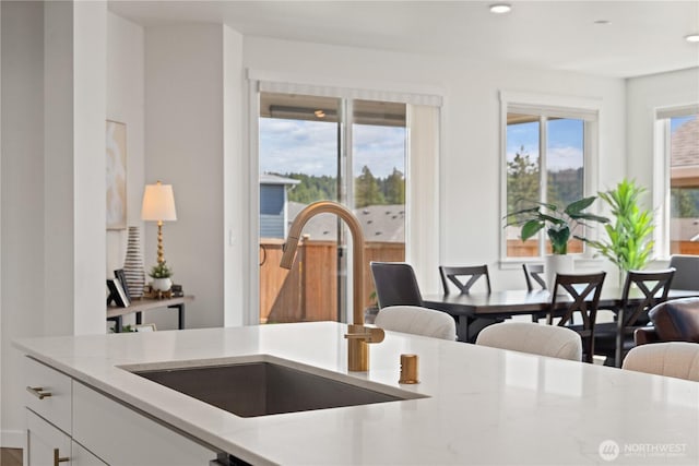12713 176th Ave E, Bonney Lake, WA 98391 - kitchen featuring light stone counters, white cabinetry, and recessed lighting