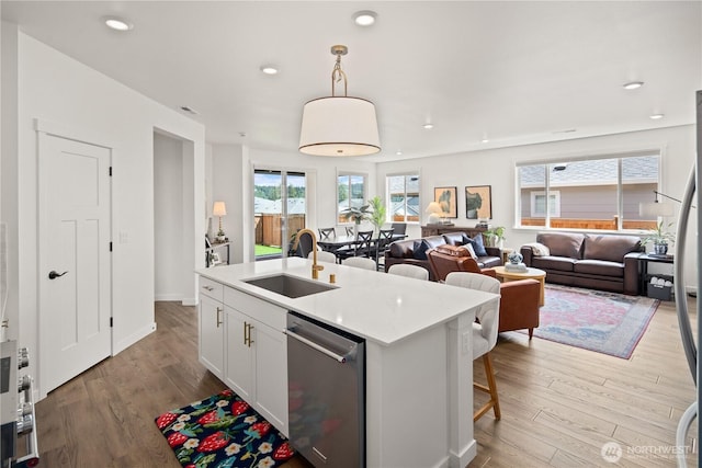 12713 176th Ave E, Bonney Lake, WA 98391 - kitchen featuring stainless steel dishwasher, open floor plan, wood finished floors, light countertops, and recessed lighting