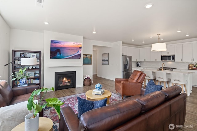 12713 176th Ave E, Bonney Lake, WA 98391 - living room with wood finished floors, recessed lighting, and a glass covered fireplace