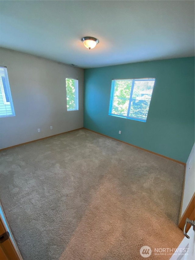 unfurnished room featuring carpet flooring