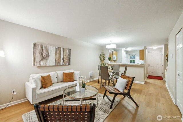 13015 102nd Ln NE Unit 2, Kirkland, WA 98034 - living room featuring light wood-style floors and baseboards