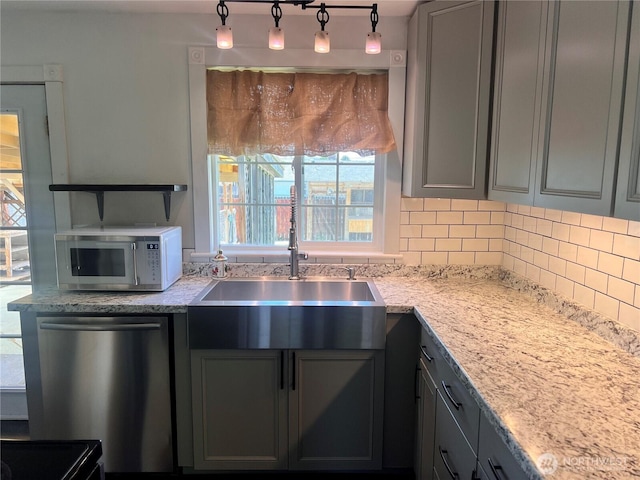 235 Ivy St NE, Ephrata, WA 98823 - kitchen with stainless steel dishwasher, a sink, gray cabinetry, and decorative backsplash