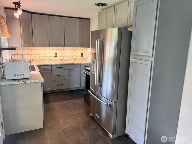 235 Ivy St NE, Ephrata, WA 98823 - kitchen with high end refrigerator, backsplash, gray cabinetry, light stone counters, and white microwave