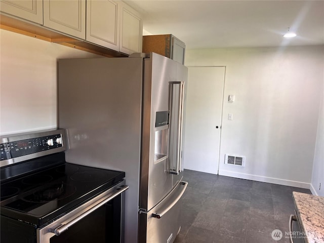 235 Ivy St NE, Ephrata, WA 98823 - kitchen featuring appliances with stainless steel finishes, baseboards, and cream cabinets