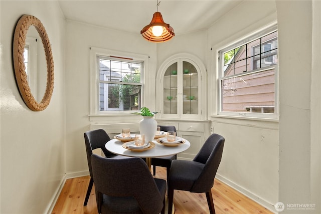 dining room with light wood-style flooring and baseboards
