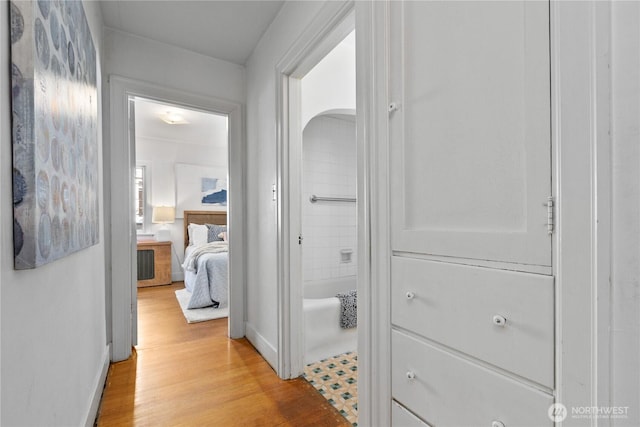 hallway with baseboards and light wood-style flooring