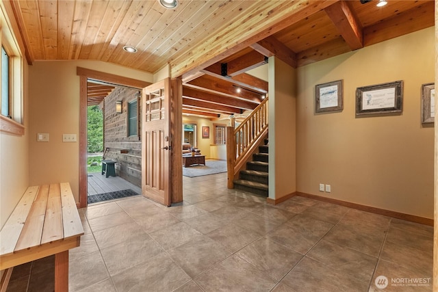 unfurnished living room with wood ceiling, stairs, recessed lighting, baseboards, and beam ceiling