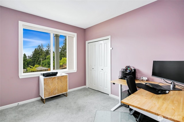 carpeted home office featuring baseboards