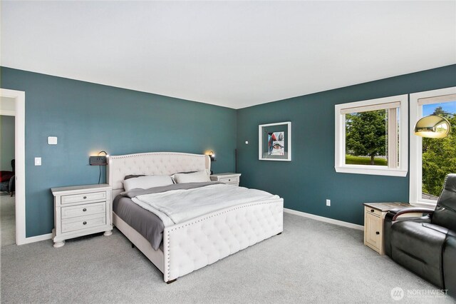 bedroom featuring baseboards and light carpet